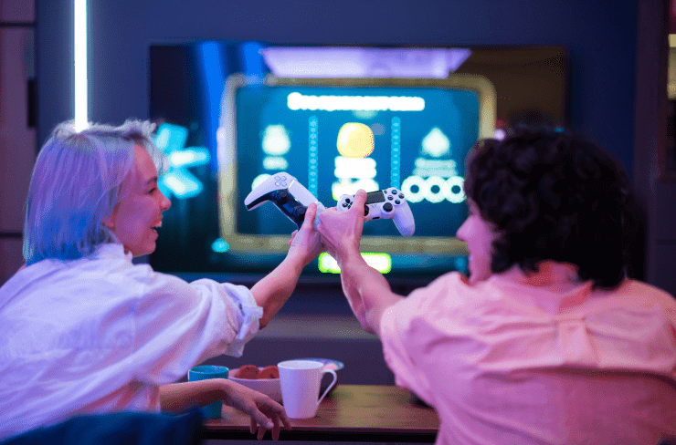 Two women holding their gaming controllers