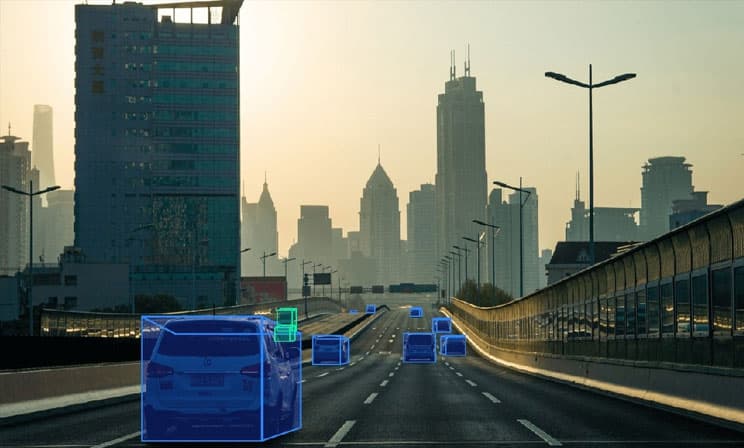 Bounding boxes on cars to indicate object detection and tracking