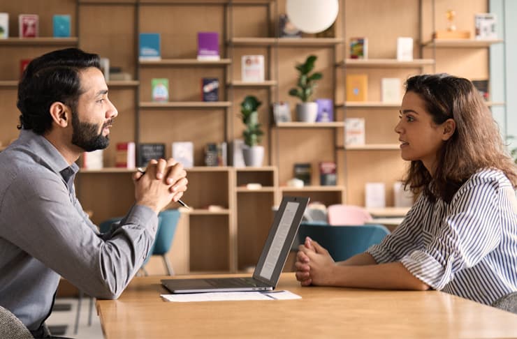 Photograph of two people meeting face to face, meant to portray recruitment