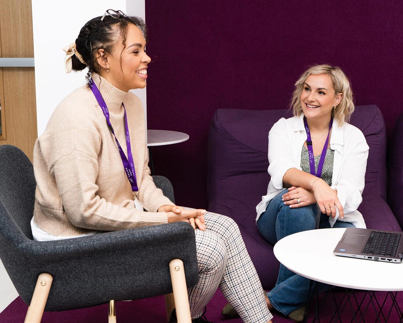 TELUS Digital team members engaged in conversation at one of our facilities.