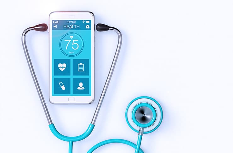 A smart phone with a stethoscope around it, showing a healthcare app.