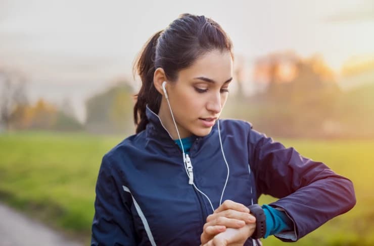 a jogger checking her fitness tracker