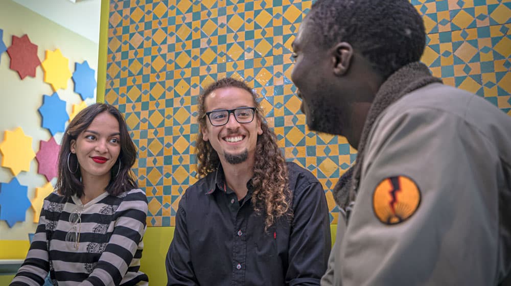 Team members conversing at Morroco site